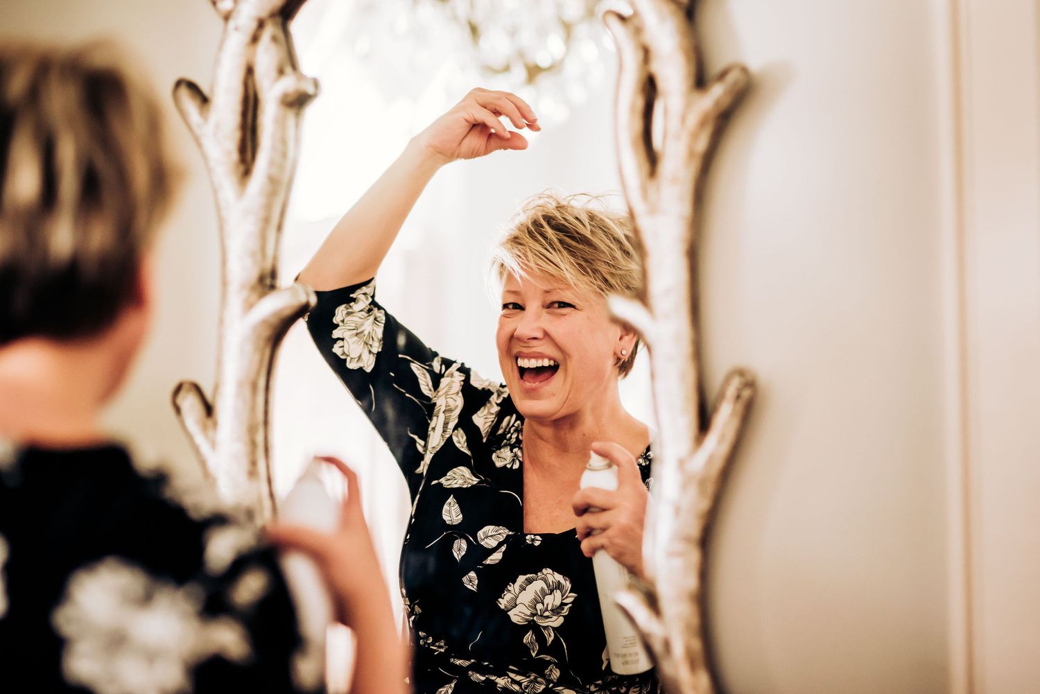 Joyful candid moment reflected in an ornate mirror.