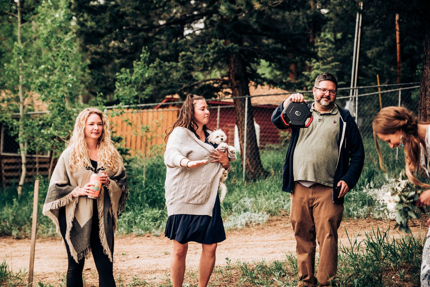 Group walking together on outdoor trail with forest backdrop.