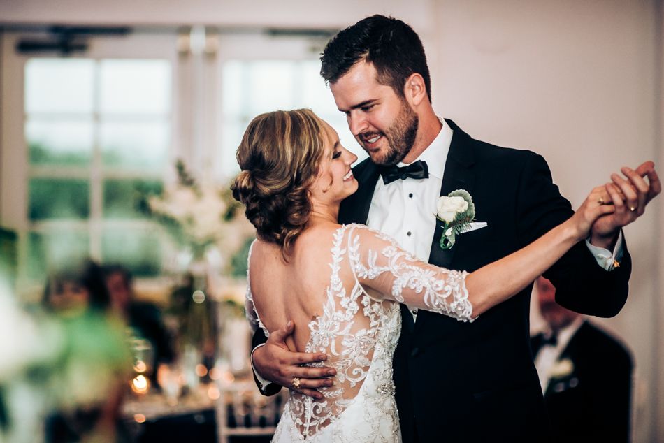 Romantic dance moment captured during wedding reception with couple in formal attire.
