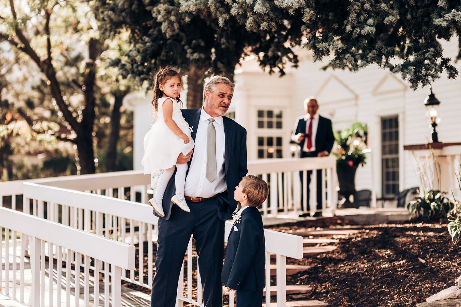 Candid moment captured on white railing walkway outside historic building.