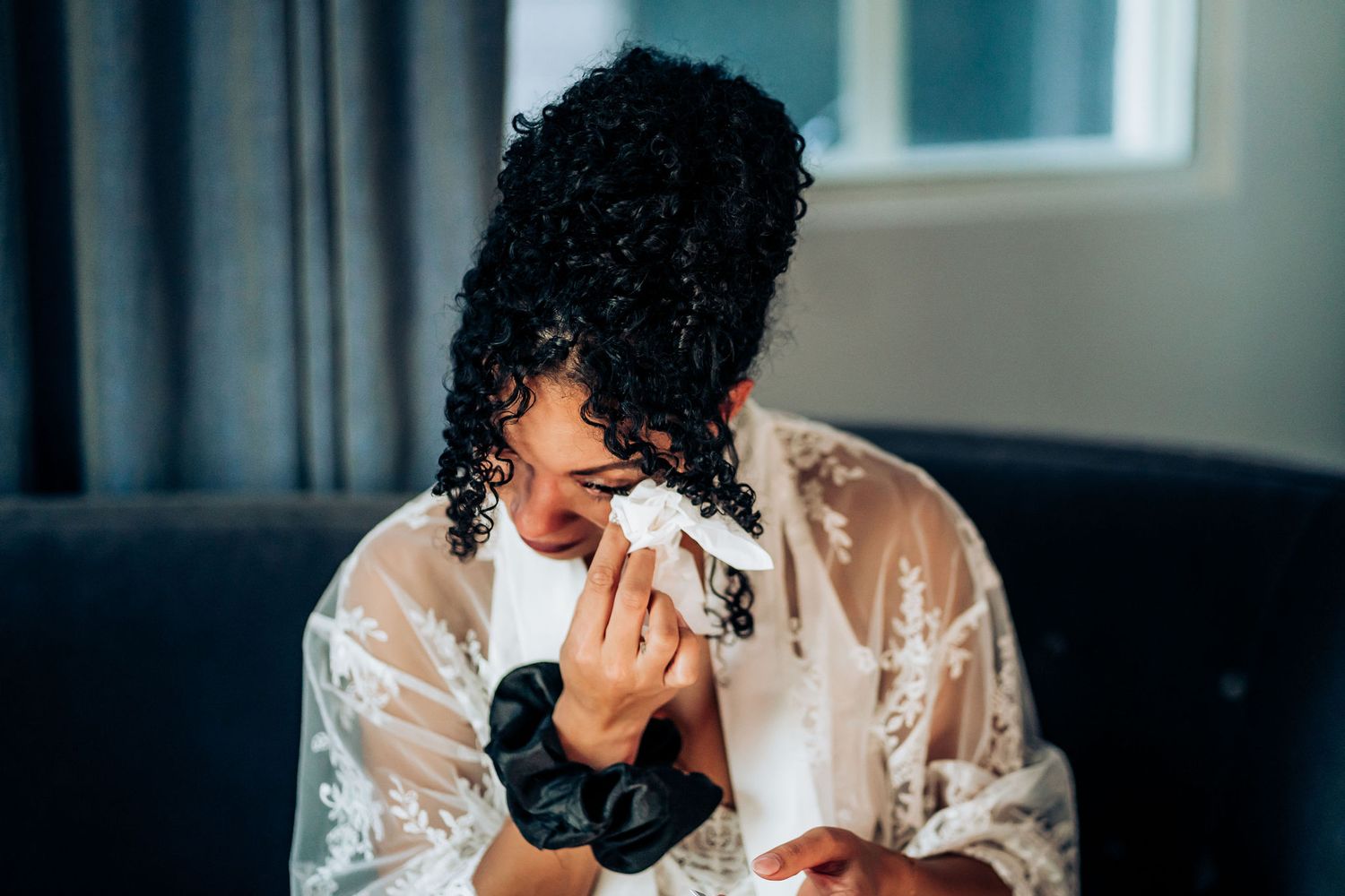 Emotional moment captured during wedding preparations.