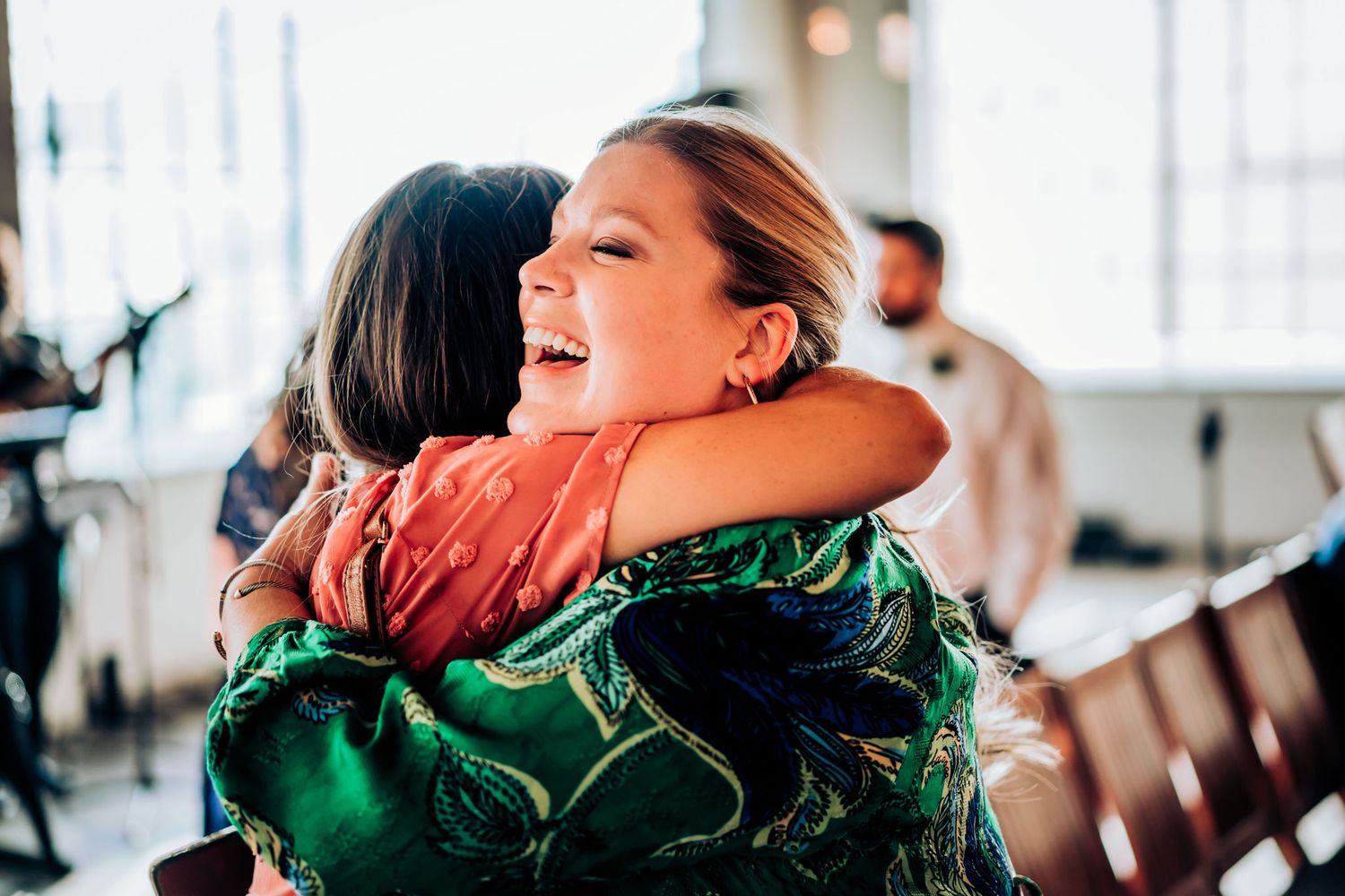 Heartwarming wedding reception moment with guests sharing laughter and joy.