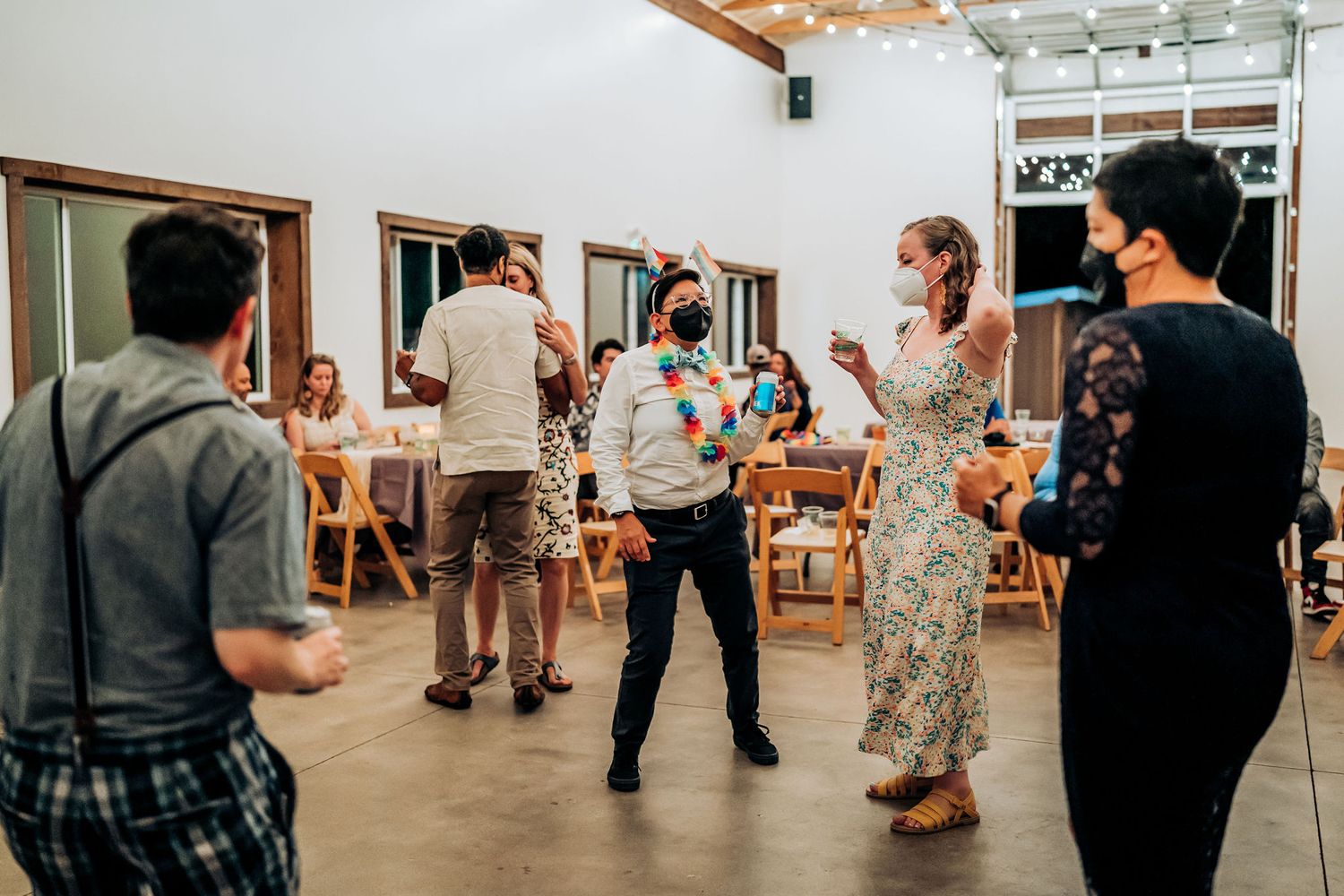 Group of people gathered in a modern indoor space during a social event.