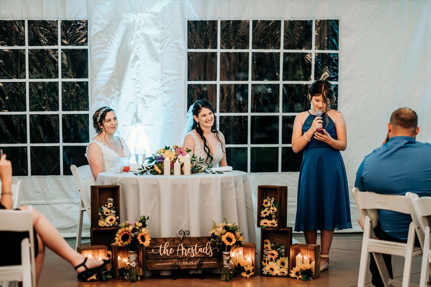 Wedding reception setup with lanterns and string lights creating a romantic atmosphere.