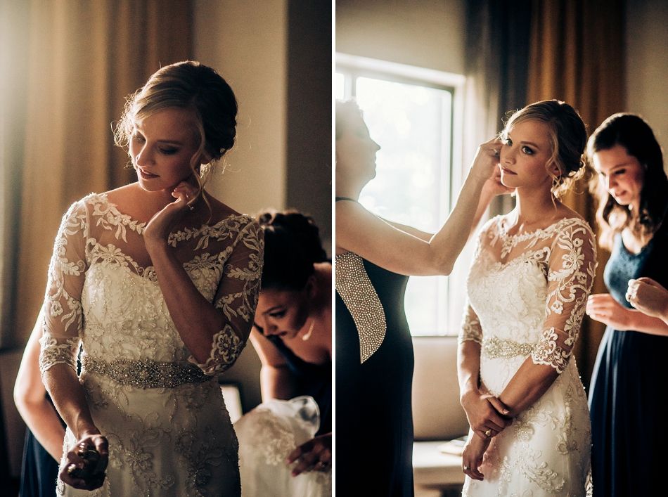 Elegant bride getting ready in a lace wedding dress with three quarter sleeves and beaded belt detail.