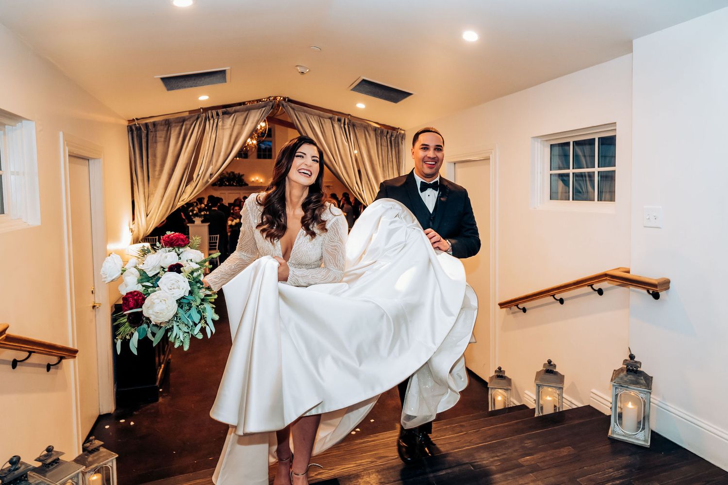 A couple playfully poses in a bridal suite with lantern decorations.