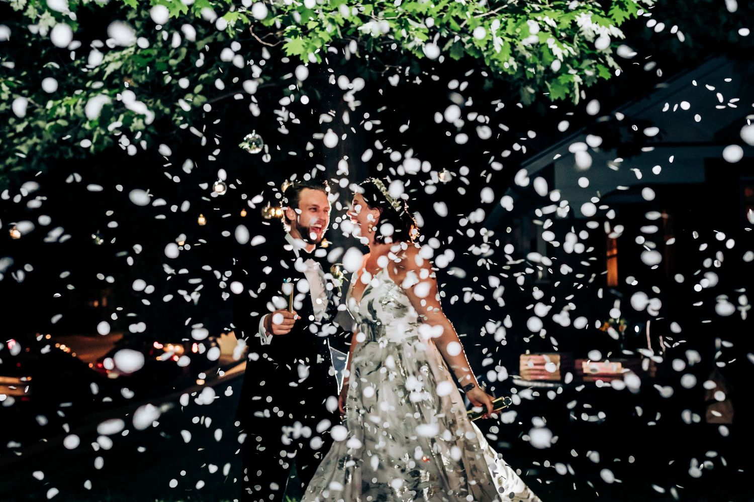 White confetti falls against a dark background creating a festive atmosphere in motion.