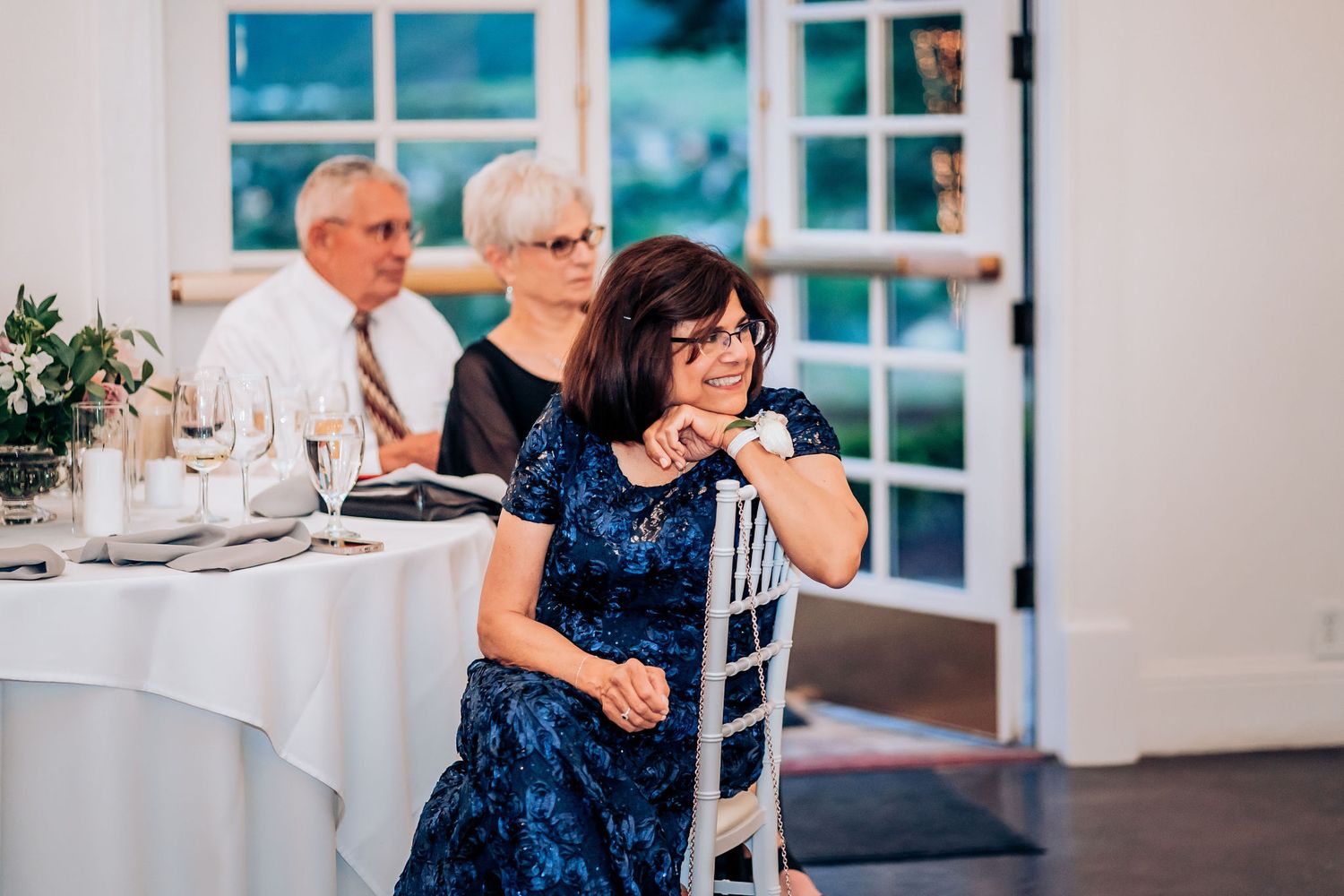 A guest in a blue dress enjoying the wedding reception festivities.