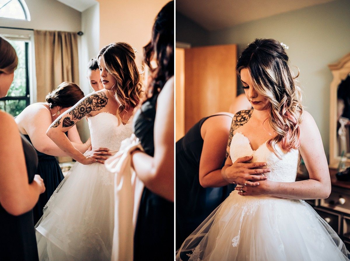 White wedding dress being adjusted and fitted on during preparation for the ceremony.
