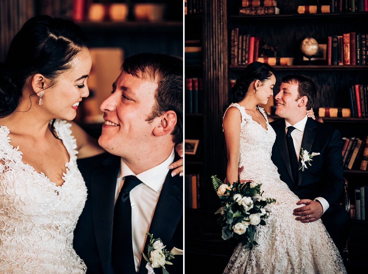Romantic wedding portraits in library setting with bride in lace dress and groom in black suit.