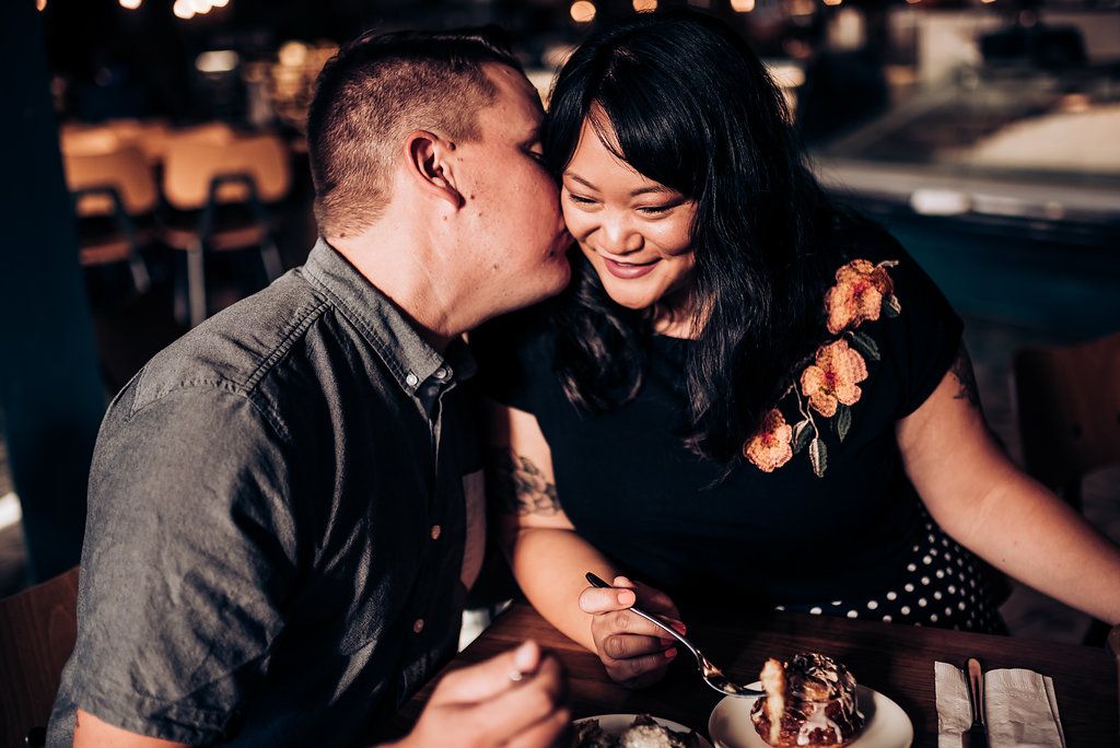 A romantic moment shared between a couple during dinner at a restaurant.