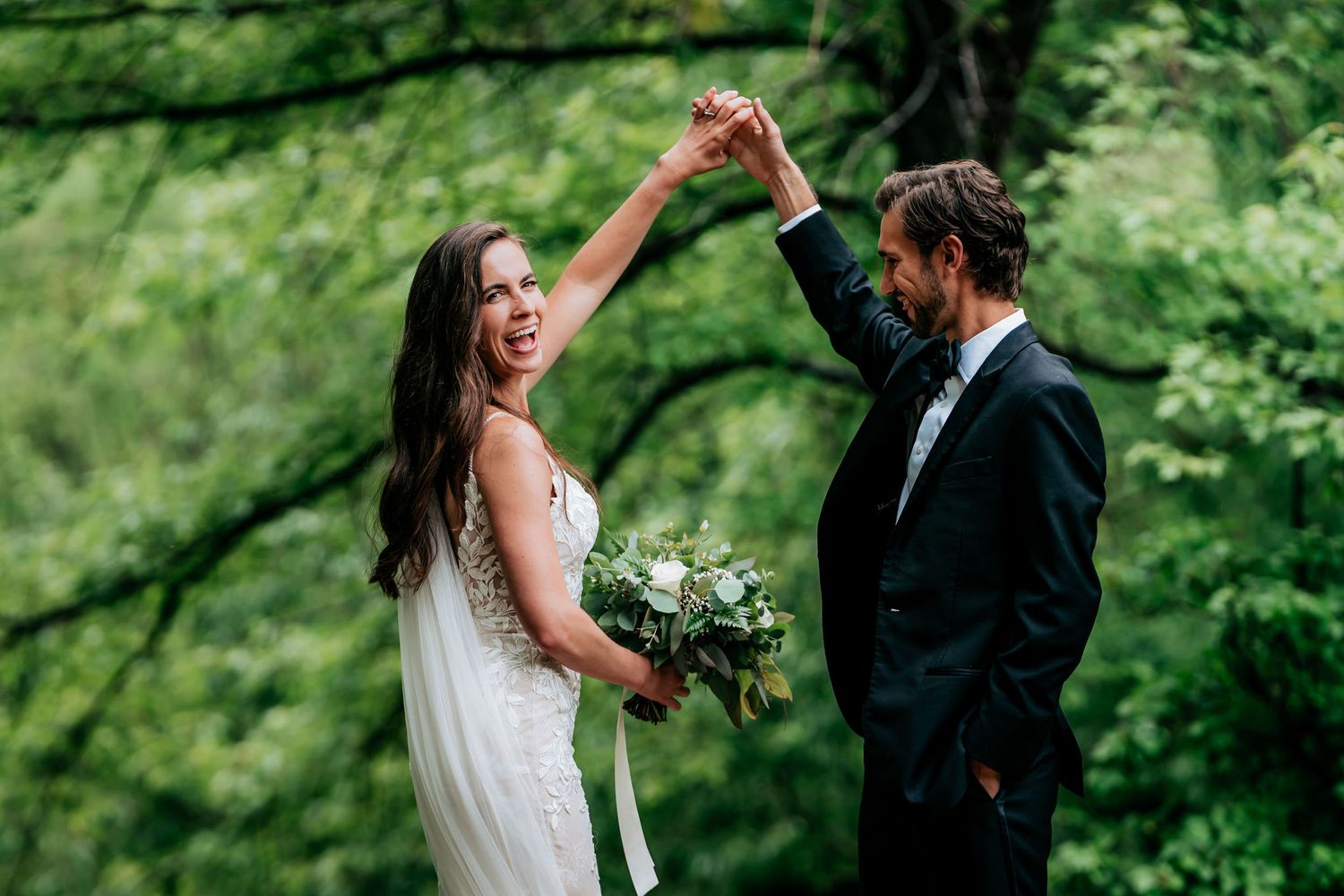 Joyful couple sharing a dance moment outdoors during their wedding.