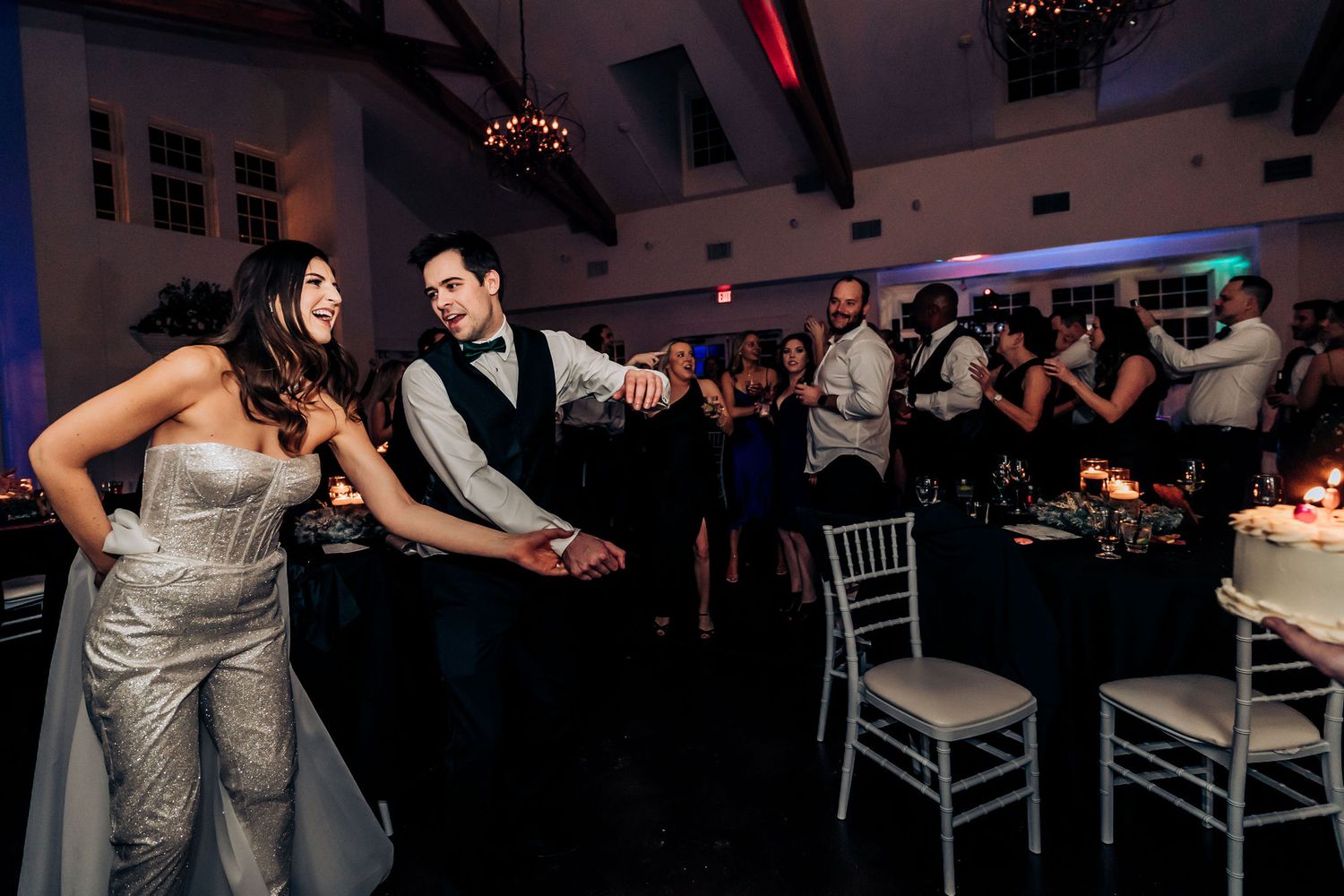 Couple enjoying a fun dance moment during their reception celebration.