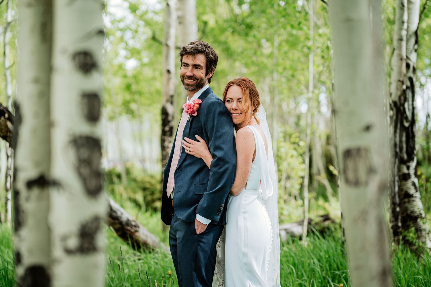 A romantic wedding photo in an aspen grove with a couple
