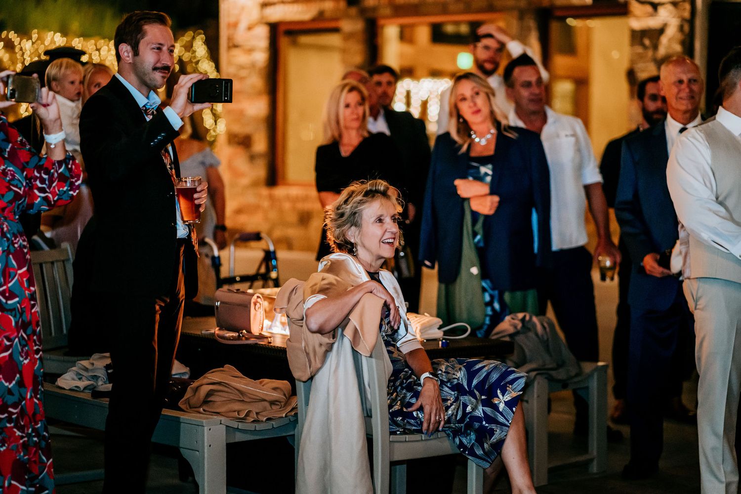 Young guest giving an enthusiastic performance during wedding reception festivities.