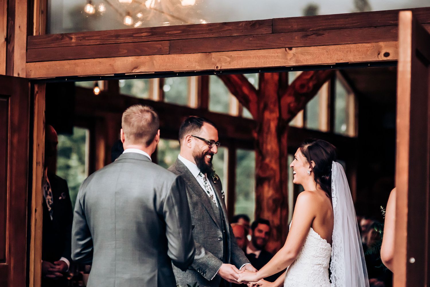 Intimate wedding ceremony moment captured in a rustic wooden venue.