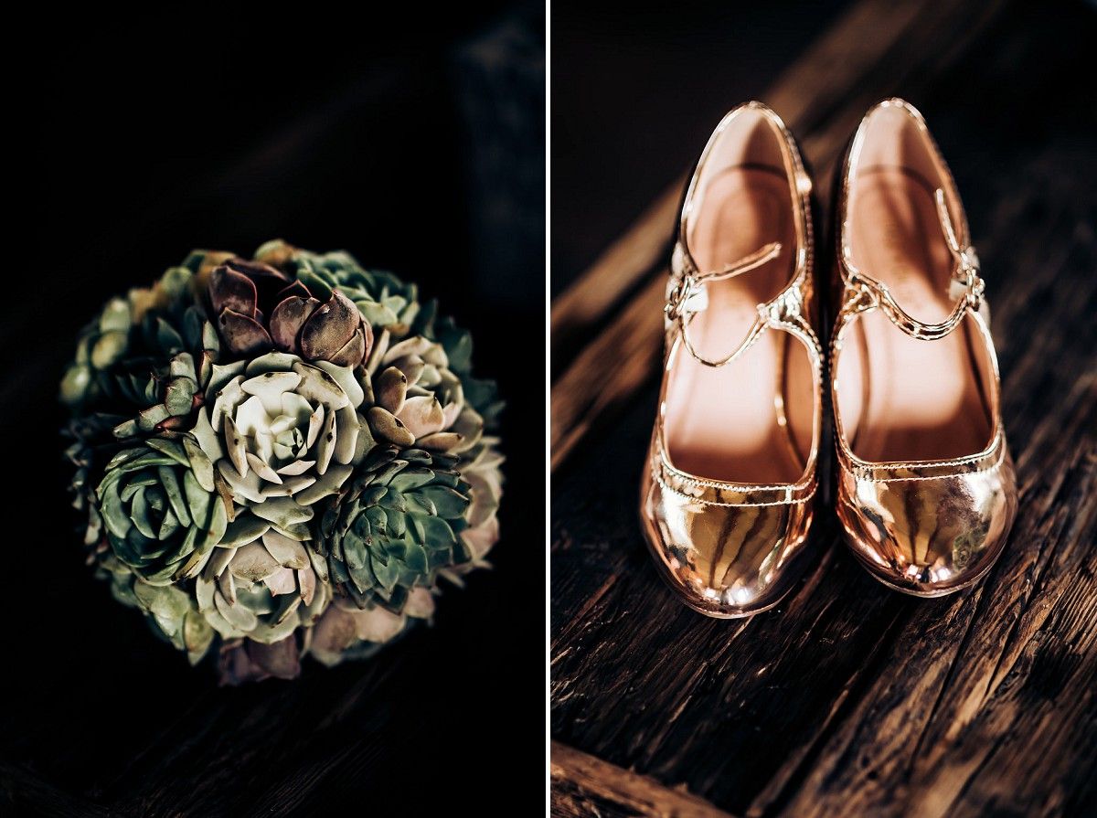 Wedding details featuring rose gold shoes and a vintage-styled succulent bouquet on dark wood.