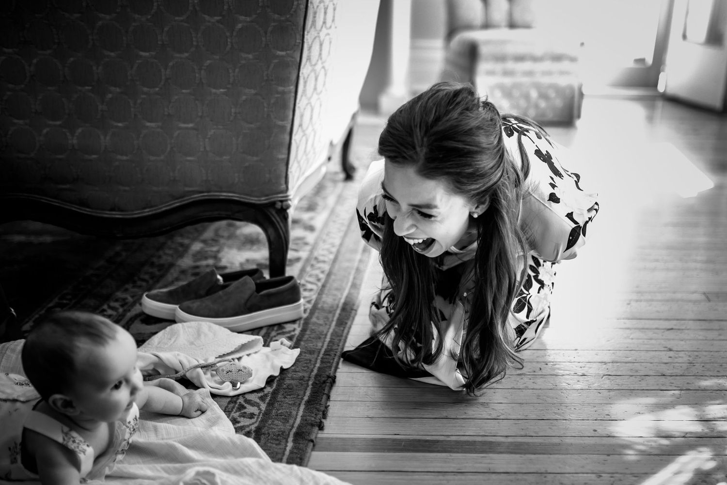 Black and white photo showing interaction on wooden floor.