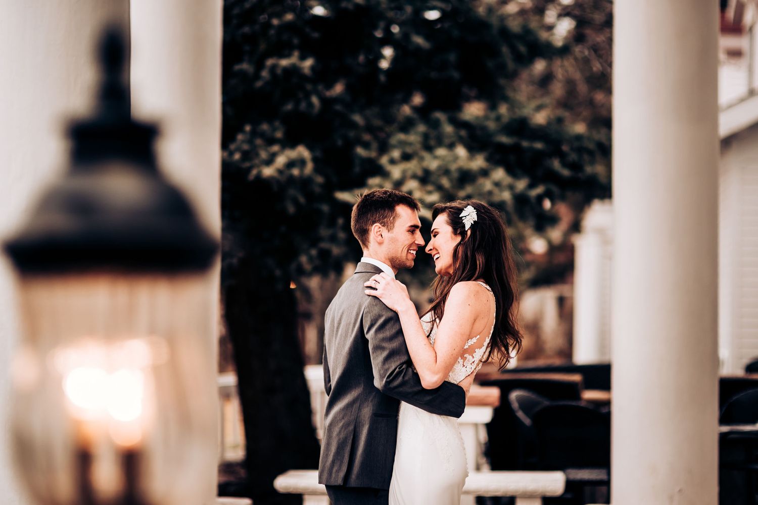Romantic couple shares an intimate moment under outdoor lighting.