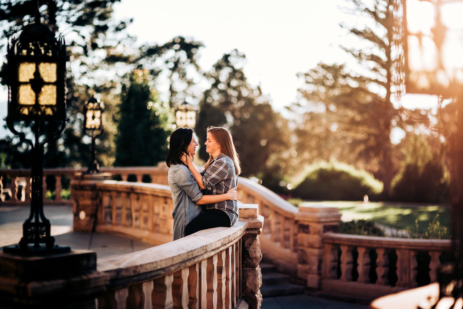 Romantic sunset moment on stone balcony with vintage lamp post.