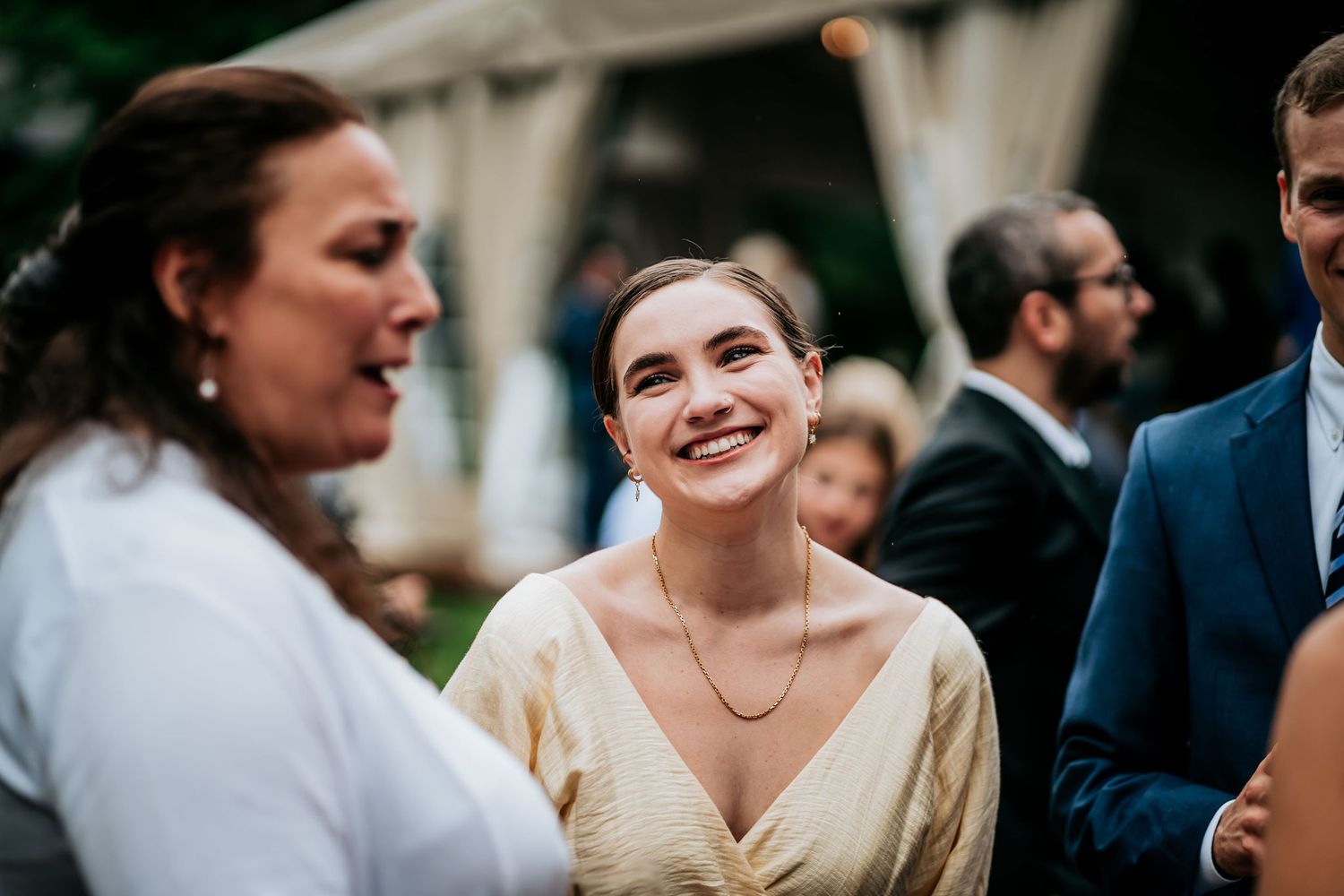 Guests share joyful moments during outdoor wedding reception festivities.