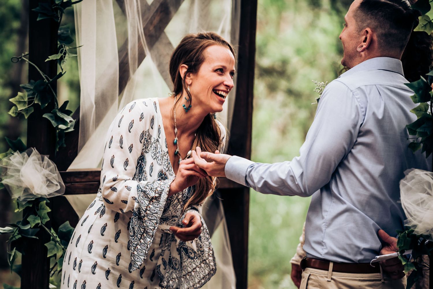 A joyful moment shared between a couple during their outdoor wedding ceremony.