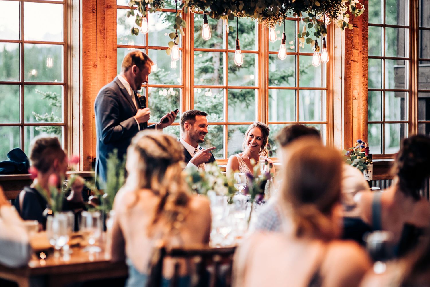 Speaker engages with wedding reception guests during emotional toast.