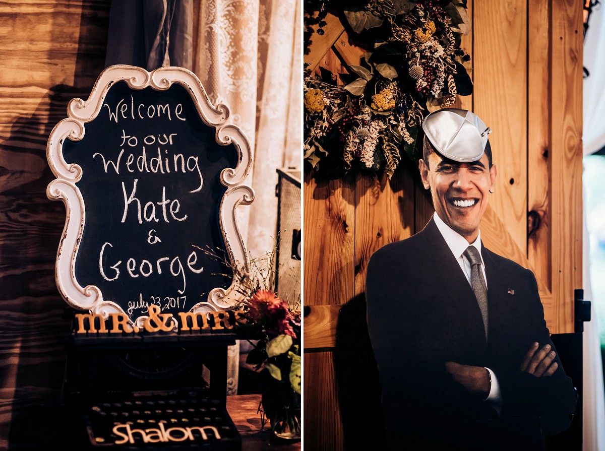 Wedding welcome sign and portrait display against rustic wooden backdrop.