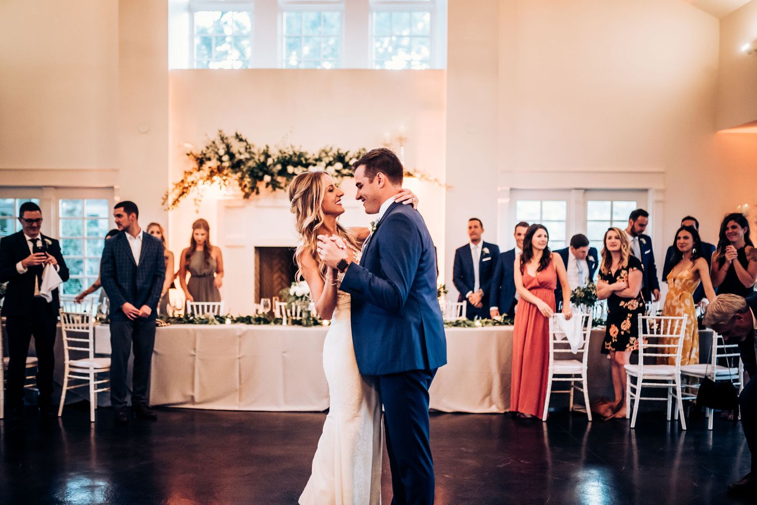 A couple shares their first dance in an elegant wedding reception venue.