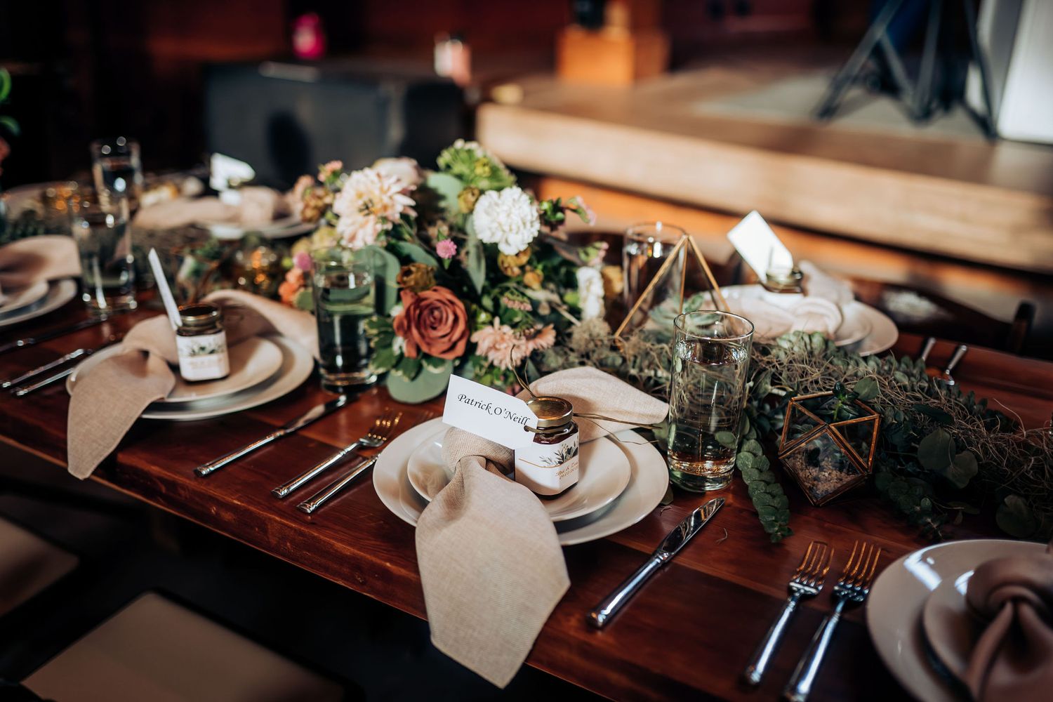 Elegant rustic wedding table setting with floral centerpieces and vintage place settings.