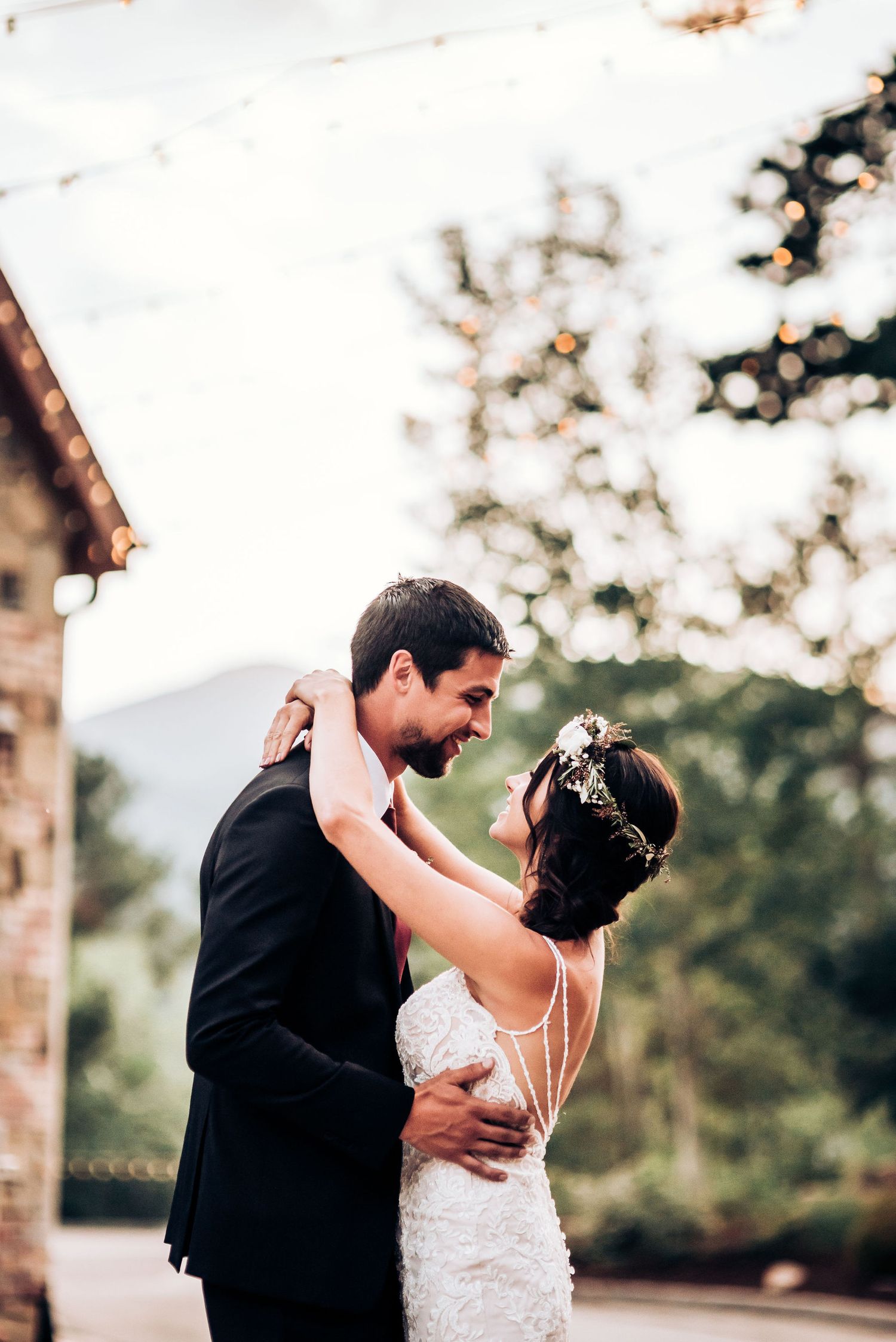 Romantic dance between newlyweds captured during outdoor wedding celebration.