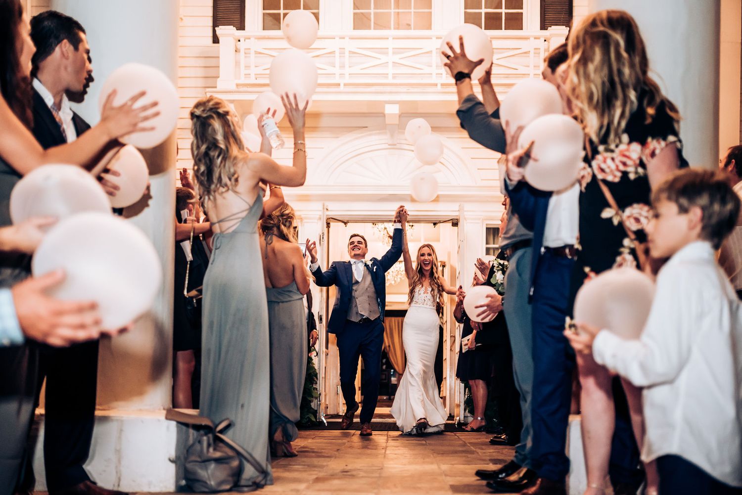 Wedding guests line up to form a celebratory tunnel for the newlyweds.