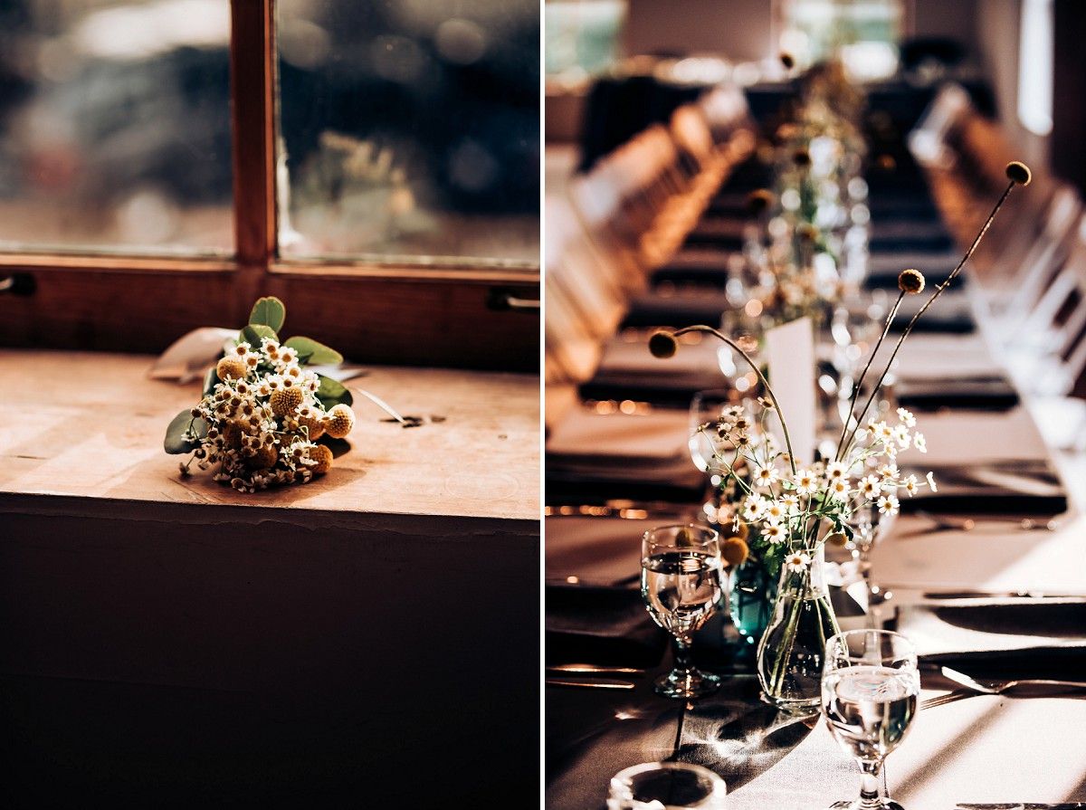 Wedding reception table settings with minimalist floral arrangements in glass vases.