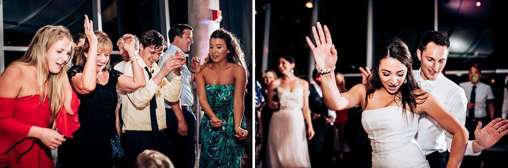 Wedding reception celebration with guests dancing and having fun on a lively dance floor.