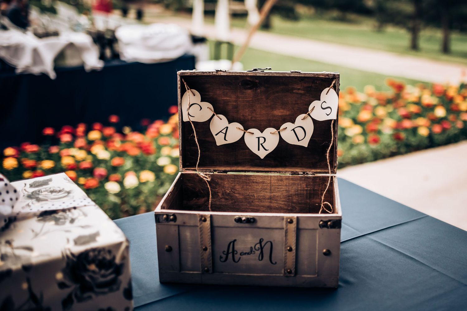 Rustic wooden chest decorated with Mr & Mrs bunting banner at wedding reception.