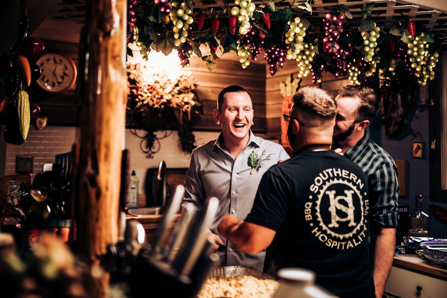 People enjoying drinks and conversation at festively decorated indoor bar.