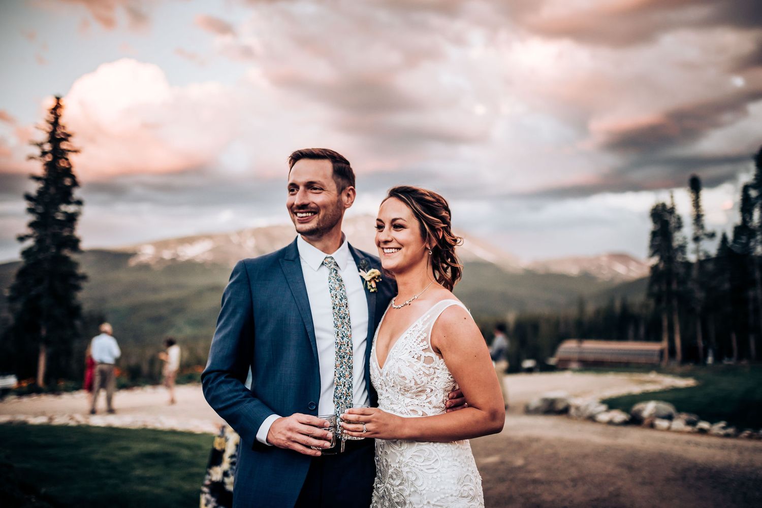 Elegant celebration outdoors with mountain landscape backdrop.