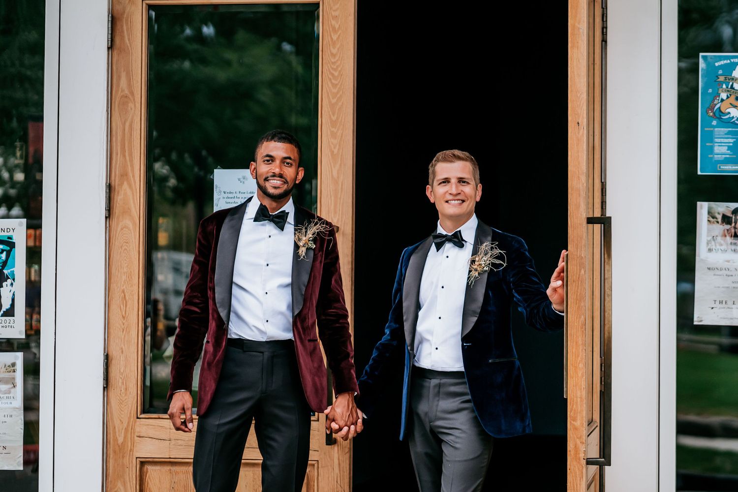 Wedding couple in formal attire exiting wooden doorway together.