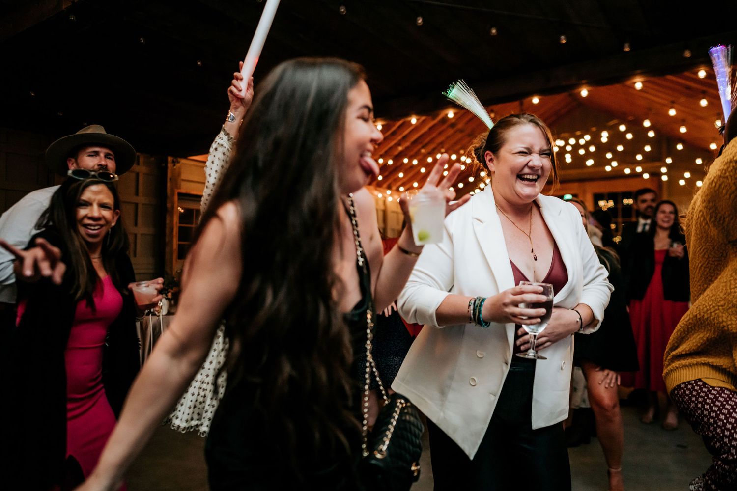 Wedding party guests dancing and celebrating with enthusiasm on a lively dance floor.