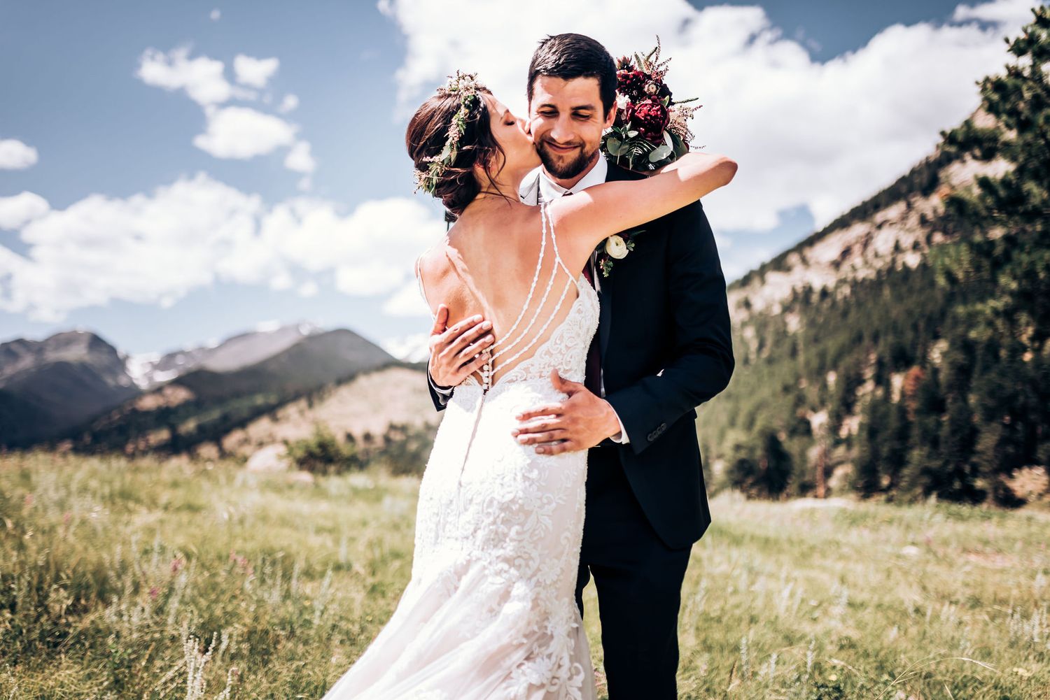 Newlyweds share intimate moment during outdoor mountain wedding photoshoot.