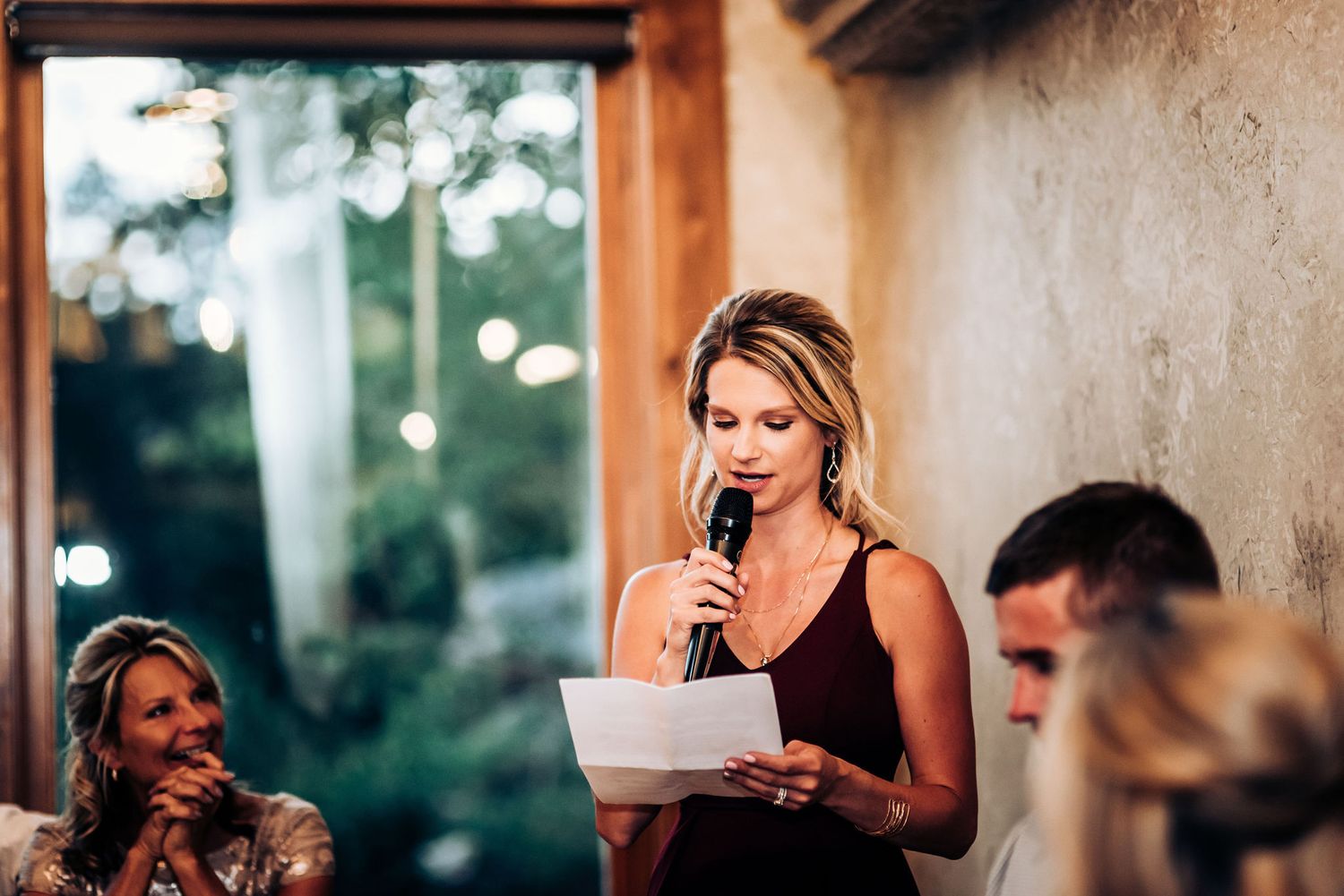 Guest delivering speech at elegant wedding reception.