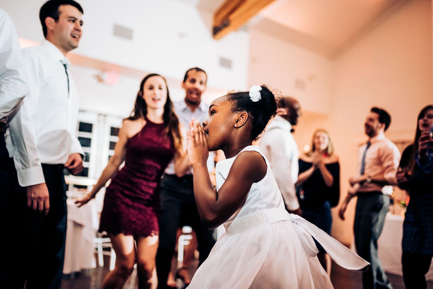 Energetic dancing and celebration at indoor wedding reception.