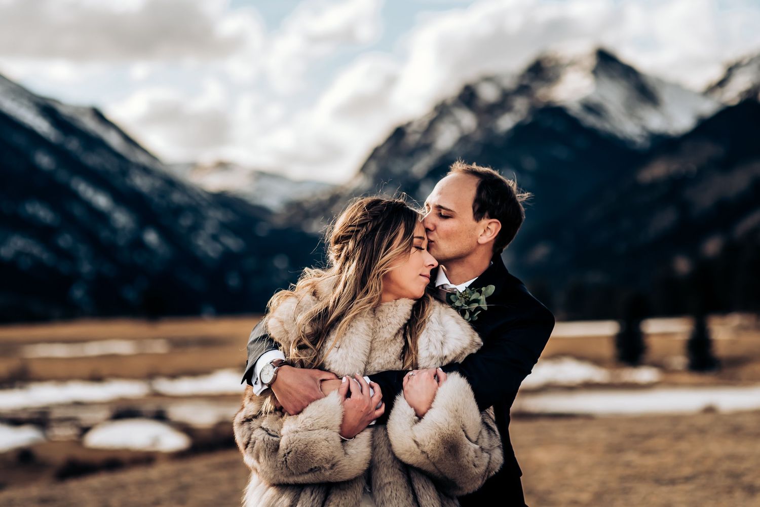 Intimate winter engagement session with majestic mountain backdrop.
