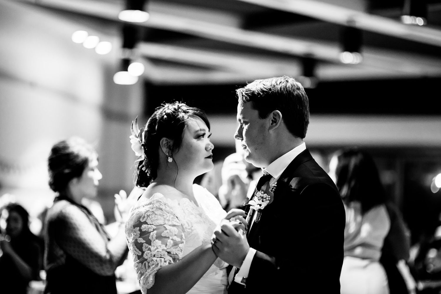 Black and white photo of a tender dance moment at a wedding reception.