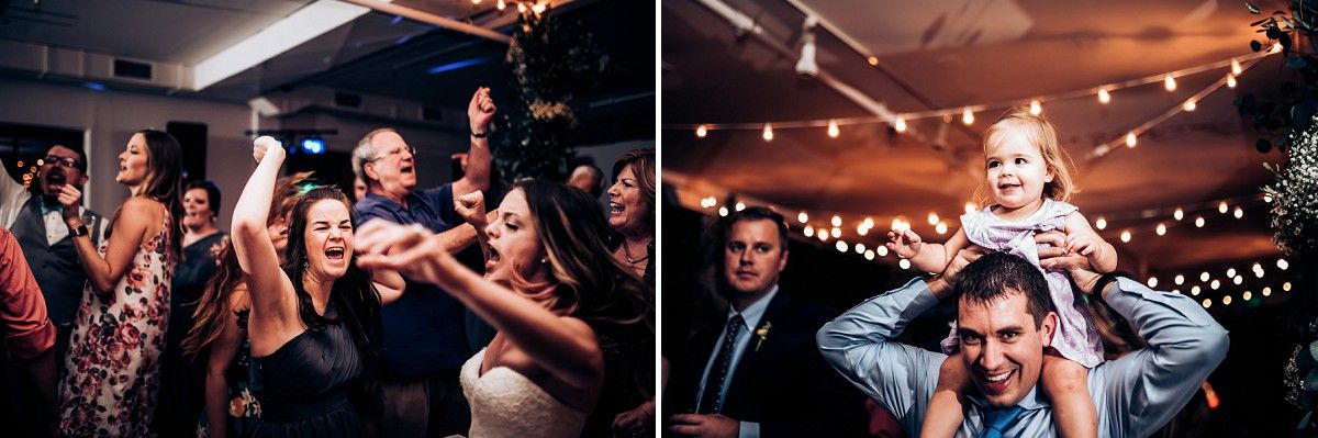 Energetic wedding reception dance floor scene with string lights overhead.