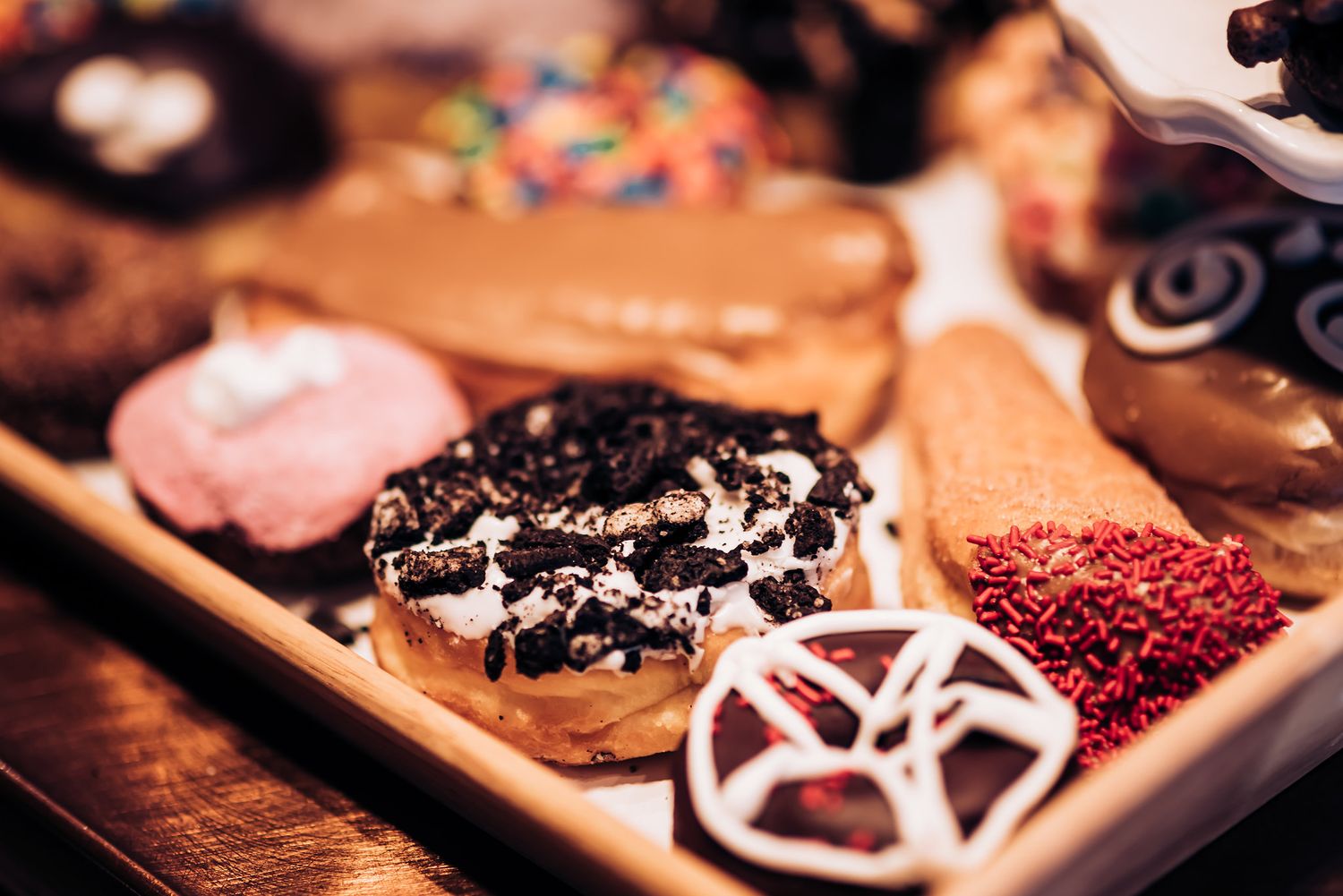 Artisanal donuts with various toppings including chocolate, sprinkles and cookie crumbles.