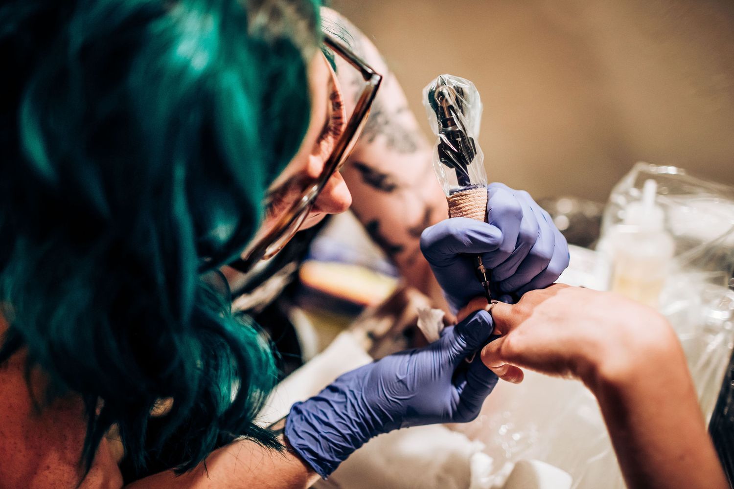 Close-up shot of hands working with artistic tools during a wedding event.