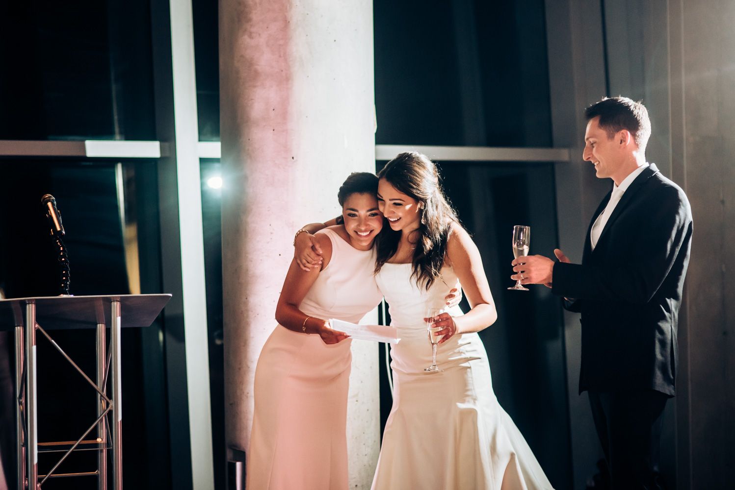 Festive wedding reception celebration with guests enjoying champagne and laughter.