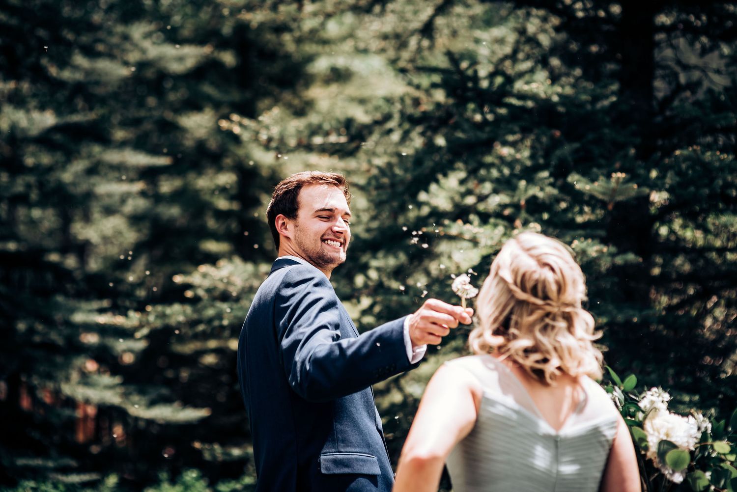 A candid moment captured between a couple during their mountain wedding ceremony.