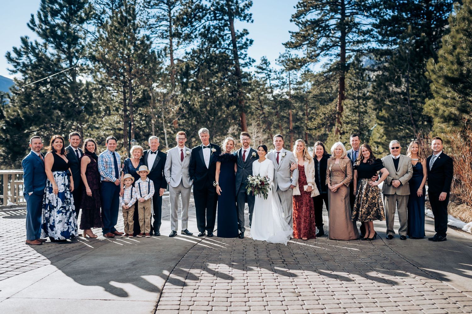 Extended family and wedding party portrait outdoors in winter mountain setting.